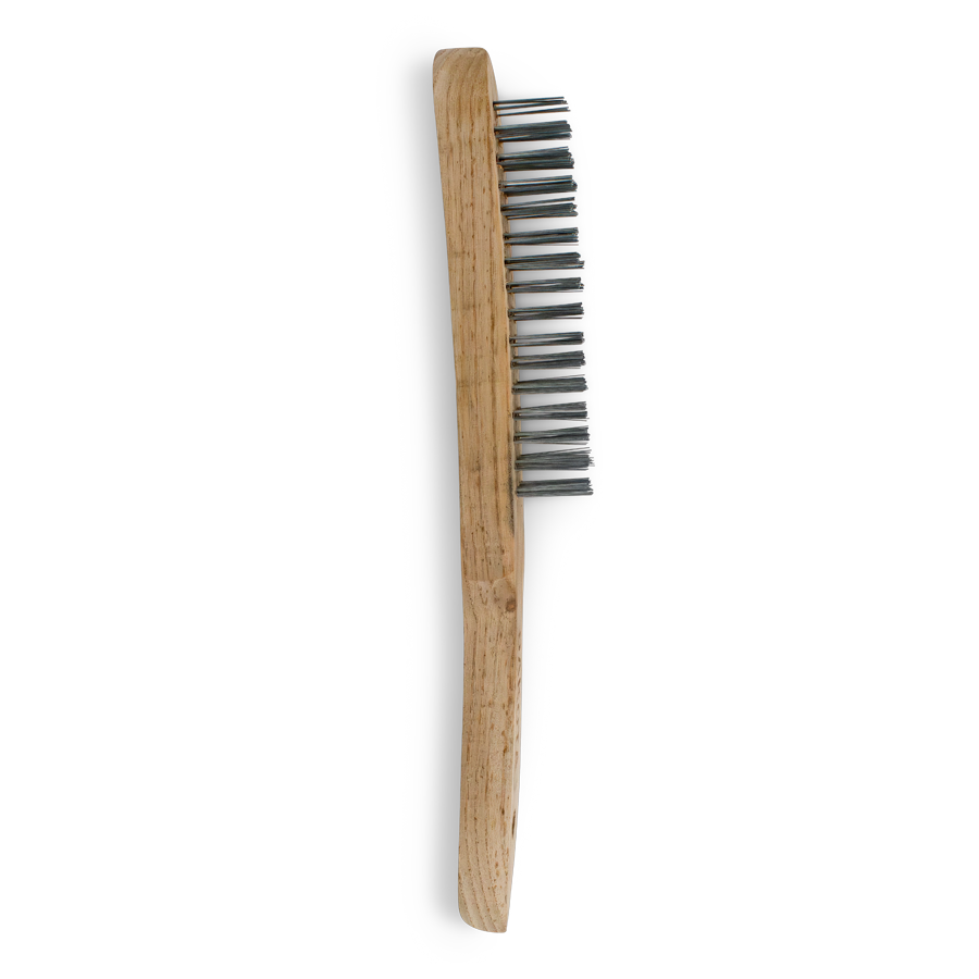 a wooden handled wire brush lays on a white background